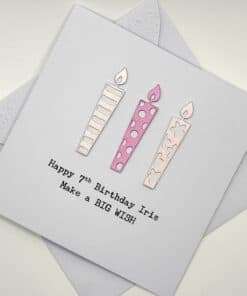 7th birthday card with candles in pink above